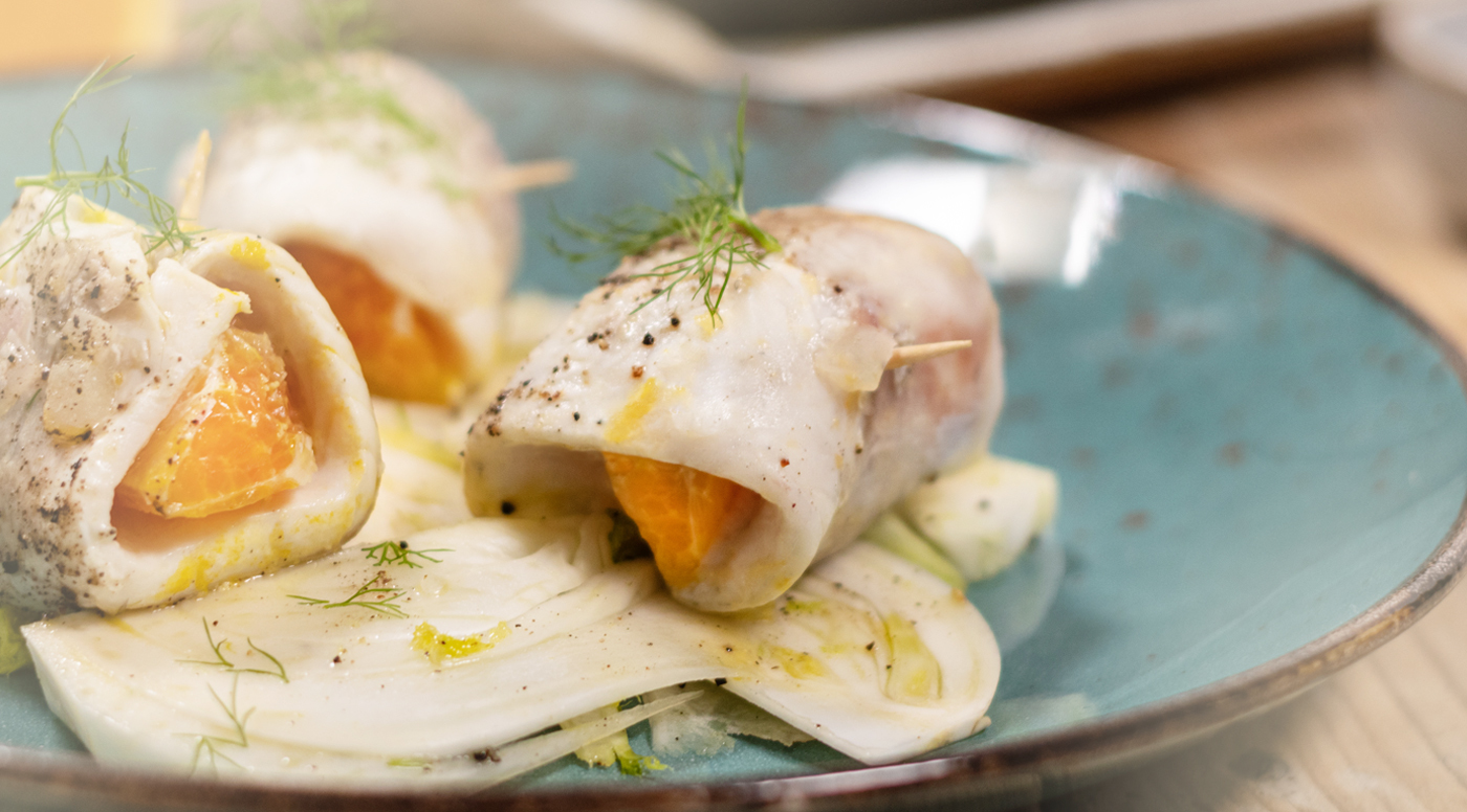 Sea bass rolls with orange and dill on a bed of fresh fennel